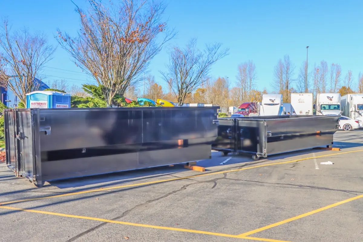 Professional dumpster rental service with roll-off container on residential driveway in Lovington